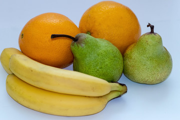 Oranges, pears and bananas on a white isolated background