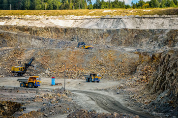 Zhodzina, Belarus - August 16, 2013: Granite mining in Quarry Trucks quarry of BelAZ