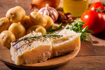 salted codfish on the wooden table with ingredients. Codfish raw.