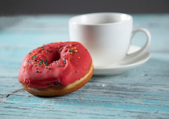 Donut and coffee on table