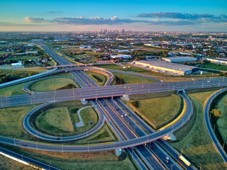 A beautiful panoramic aerial drone view of the sunset on the highway overpass of the southern Warsaw bypass (Polish: POW), Michalowice district in Warsaw, Opacz Kolonia, Poland