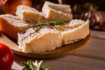 salted codfish on the wooden table with ingredients. Codfish raw.