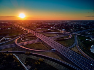 Fototapeta na wymiar A beautiful panoramic aerial drone view of the sunset on the highway overpass of the southern Warsaw bypass (Polish: POW), Michalowice district in Warsaw, Opacz Kolonia, Poland