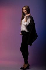 portrait of a brunette girl in the studio on a multi-colored
background near the barrel. Cosmetics advertising. Copy space. Vertical view
