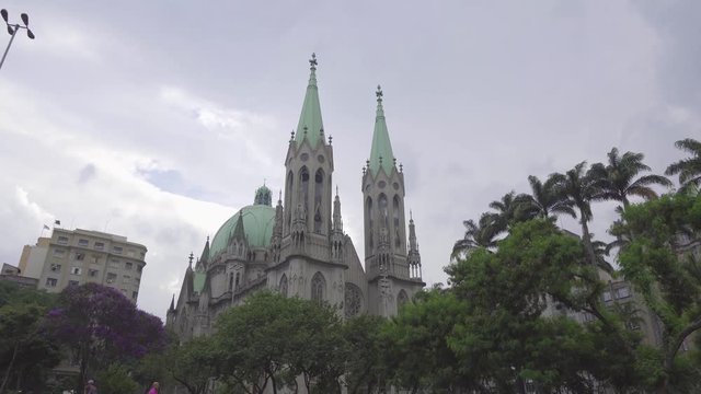 View of Se Cathedral, with imperial palms at the front and blue sky. Sao Paulo. Brazil. 15 march, 2019. Cripta da Catedral da Se. 4k video. Part2