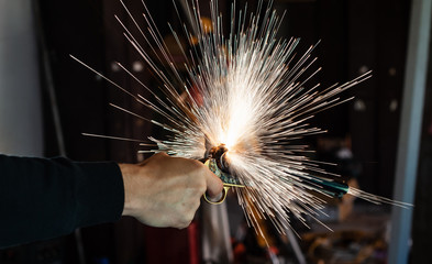 Side view of a hand holding an old cowboy gun. Big bang, smoke and sparks of black gunpowder....