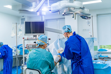 Clinic interior with operating surgery table, lamps and ultra modern devices, technology, hi-tech interior, medicine concept