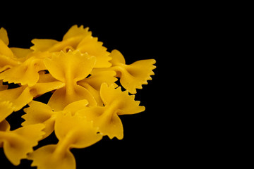 yellow pasta isolated on black background