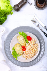Diet chicken cutlets with oatmeal porridge. Vintage appliances on a white background. The concept of healthy eating. Copy space.
