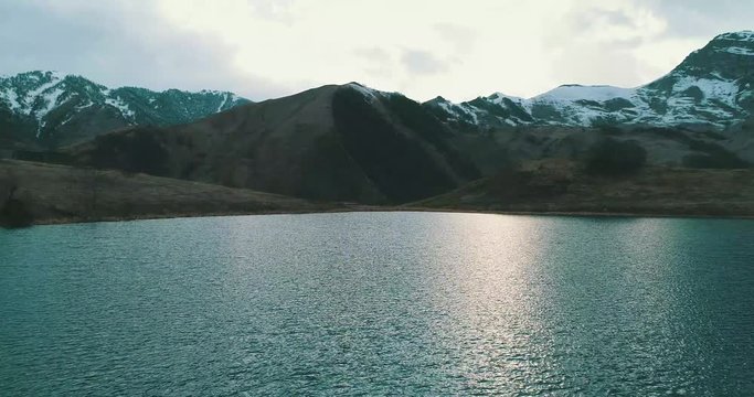 beautiful sunset in the autumn lake of the mountain. Aerial view shot 4k drone.
