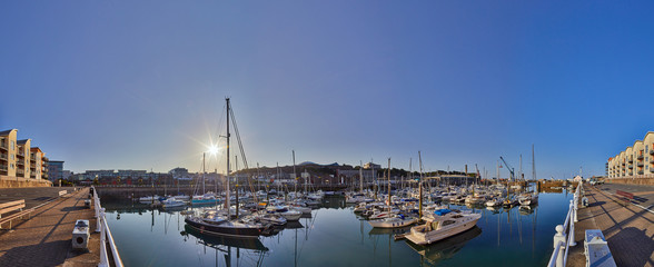 Panoramic image of St Helier Marina early morning from the West marina wall with the visitor births on the left hand side of the image. Jersey, Channel Islands, UK