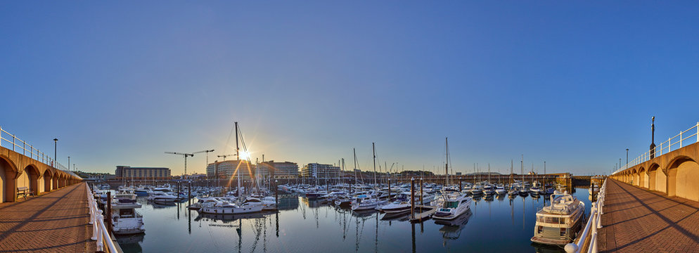 Panoramic image of Elizabeth Marina, St Helier early morning from the West marina wall with the entrance to the marina on the right hand side of the image. Jersey, Channel Islands, UK