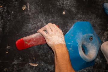 hand climbing on a rock wall