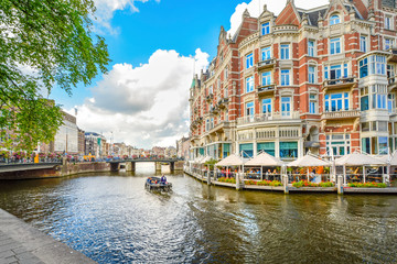 Tourists enjoy a relaxing waterfront lunch at a hotel on one of the major canals near the Museum...
