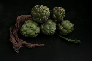Fototapeta premium Three artichokes tied with a cloth