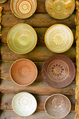 Collecton of empty ceramic bowls on rustic background, vertical image