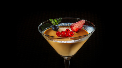 panakota in a glass glass on a black background