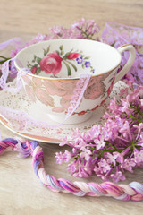 Lilac flowers with vintage cup, violet and purple colors