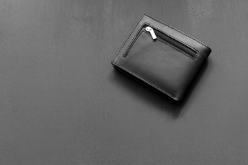 black leather wallet on a gray painted background