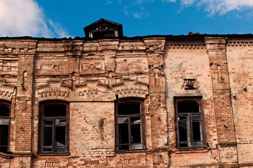 old abandoned house in the old town broken windows of an old brick house