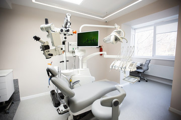 Modern Dental Clinic, Dentist chair and other accessories used by dentists in medical light. Dental surgeon, is a surgeon . Dentist's office. Dental equipment in modern, clean interior