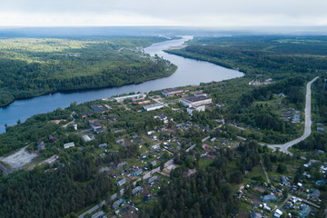 Aerial view of the Svir river and houses in urban-type settlement in Leningrad region, Russia.