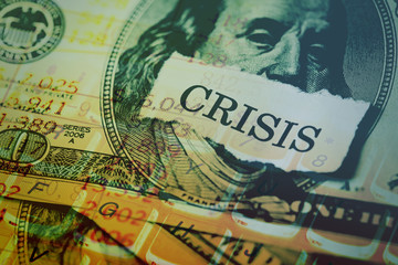 USA dollar with crisis text on paper
