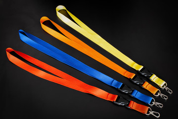 Colorful badge cords on the black background. Isolated