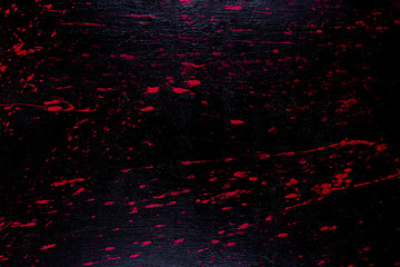 Red and black melted painted wooden board texture background.
