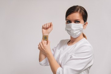A female doctor shows on her hand how to insert a microchip identification of people's data.