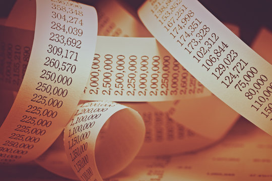 Rolled calculator paper tape.Gold tone.
