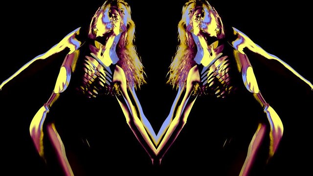 a woman with long hair and her mirror reflection dance on a black background. the image is split. the colors change