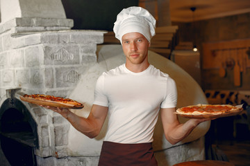 Chef prepare the pizzaa. Man in a white uniform