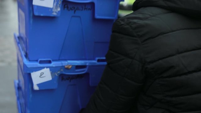 Close Up. The Hands Of An African-American Male Push Blue Boxes With Goods. Food Delivery, Street Courier