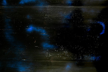 Black and blue background of painted texture on wood plank.