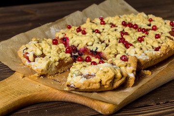 sliced ​​homemade grated pie with berries