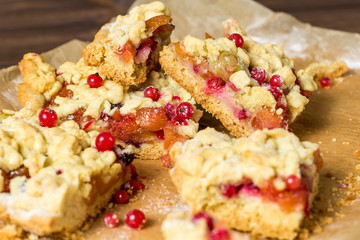 tasty breakfast. sliced ​​homemade grated pie with berries on a wooden board.