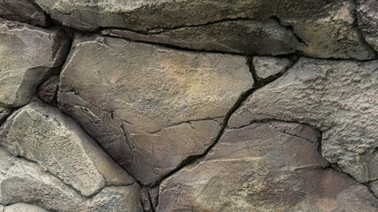 Grey stone wall with cracks. Texture Background. Closeup