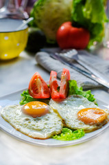 Fried eggs from two eggs on a plate