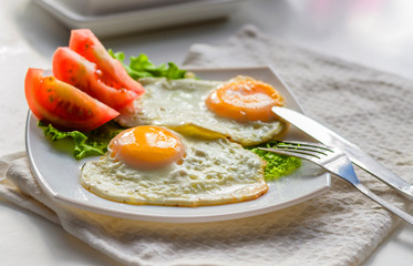 Fried eggs from two eggs on a plate