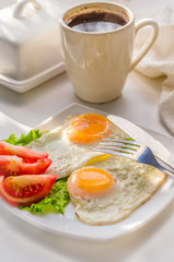 Fried eggs from two eggs on a plate