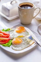 Fototapeta na wymiar Fried eggs from two eggs on a plate