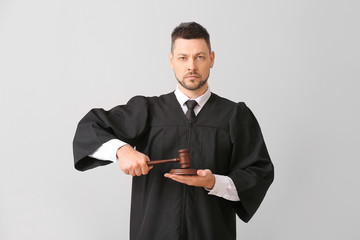Male judge on light background