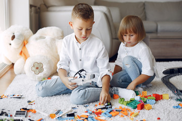 Brother and sister in a playing room. Children playing with a blocks