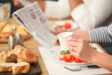 Happy elderly couple having breakfast at home