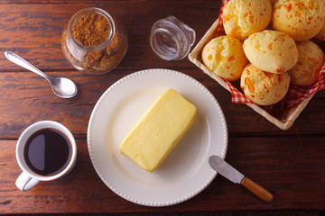homemade cheese bread, traditional Brazilian snack, on the breakfast table in a rustic farm kitchen