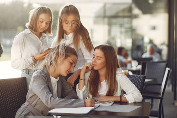 Students in a park. Girls on a campus. Friends sitting at the table.