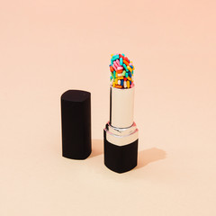 Creative concept with lipstick with colorful cake sprinkles. Minimal make up background. - 353255002