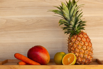 Fruits Selection (pineapple, orange, mango) and vegetables (carrots)..