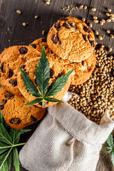 Cookies with cannabis and buds of marijuana on the table. A can of cannabis buds CBD Concept of cooking with cannabis herb. - Medical Legal Marijuana